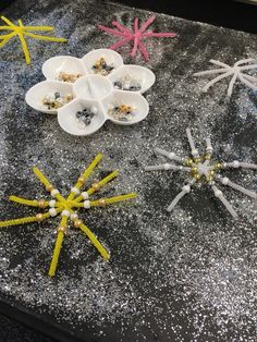 several different types of starfish on a table with beads and other things in them