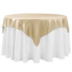 a gold and white table cloth on top of a round table with an overlay