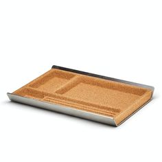 a metal tray with a corked surface on it and an empty plate in the middle