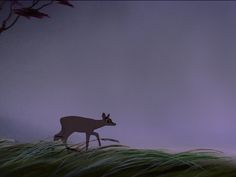 a deer is walking through the grass in front of a purple sky and some trees