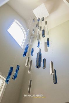 the light fixture is hanging from the ceiling and has blue glass blocks attached to it