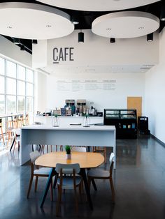 the interior of a coffee shop with tables and chairs