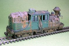 an old model train is sitting on the tracks and ready to be built into action