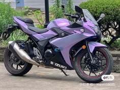 a purple and black motorcycle parked on the street