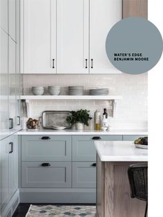 a kitchen with white cabinets and blue paint on the counter top, along with a rug