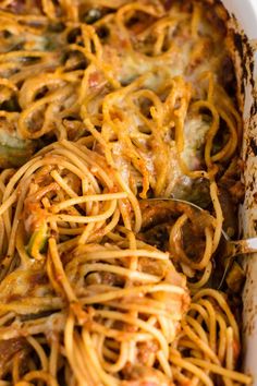 a casserole dish with spaghetti and sausage in it, ready to be eaten