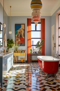 a bathroom with an orange and white bathtub next to a large painting on the wall