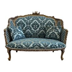 an ornately decorated couch with blue and white fabric on the back, against a white background