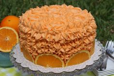 there is a cake with oranges on the table