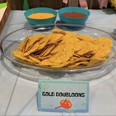 a glass platter filled with tortilla chips