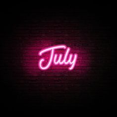 a pink neon sign that says july on a brick wall with the word'july'written in cursive font