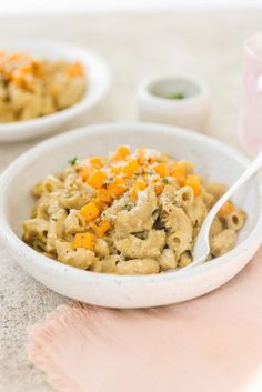 a bowl filled with macaroni and cheese on top of a table