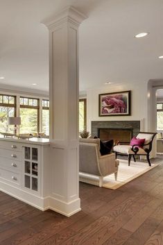 a living room filled with furniture and a fire place in the middle of a room