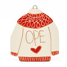 a ceramic ornament with an open heart on it's chest and the words,