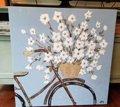 a painting of a bicycle with white flowers in the basket on it's front wheel