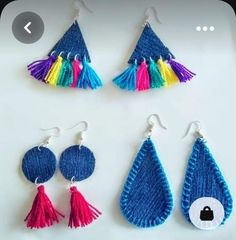 three pairs of earrings with tassels are shown on a white surface, one is blue and the other is pink