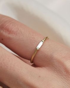 a woman's hand with a gold ring on it