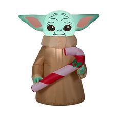 an inflatable star wars character holding a candy cane with the child yoda on it