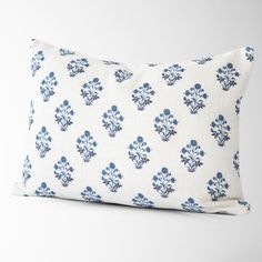 a white pillow with blue flowers on it