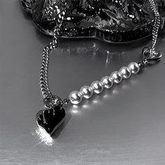 Unique black melt heart pendant half pearl half layered silver chunky chain necklace choker. Iconic romantic dark style/Gothic/punk/street wear jewelry for men and women. Stylish edgy design with sturdy handmade details, adjustable length, easy to wear and stack, modern chicness with a bit vintage goth accent. Amazing statement layering necklace to elevate your everyday fashion vibes. ♥ Same style matching earrings also available in our store 💎 Features:♥ Handmade♥ Finish tone: silver, black♥ C Punk Pearl Necklace, Pearl Layering, Cyberpunk Black, Heart Pendant Necklace Silver, Punk Choker, Melting Heart, Streetwear Jewelry, Chunky Chain Necklace, Goth Necklace