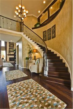 an image of a staircase in a house with carpet on the floor and rugs on the ground