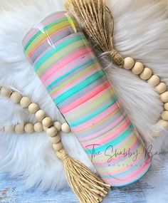 a colorful tube with tassels and beads on a white furnishing area