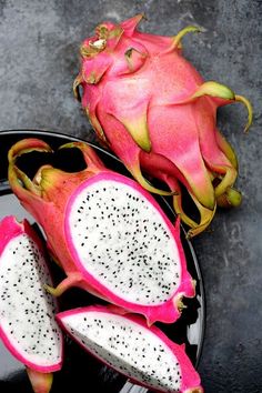 a dragon fruit cut in half on a plate