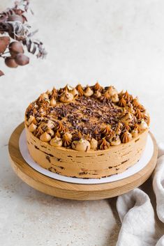 a cake with nuts on top sitting on a plate