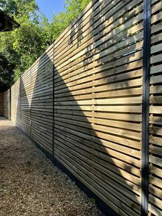 a long wooden fence in the middle of a park