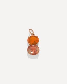 an orange stone pendant on a white background