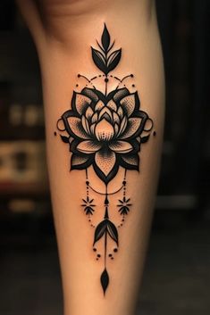 a woman's leg with a tattoo on it that has a flower and arrows