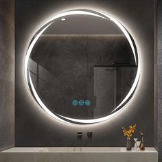 a bathroom with a round mirror above the sink