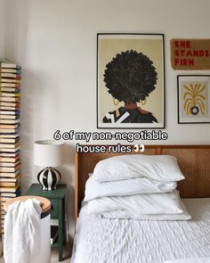 a bed with white sheets and pillows in a bedroom next to a book shelf filled with books