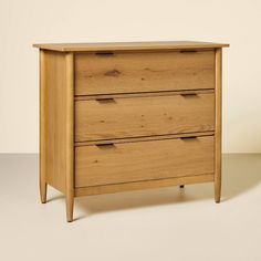 a wooden dresser sitting on top of a white floor