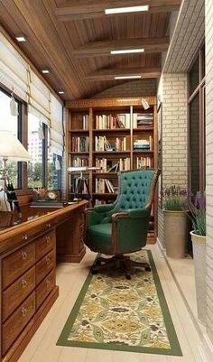 a chair sitting in front of a desk next to a book shelf filled with books