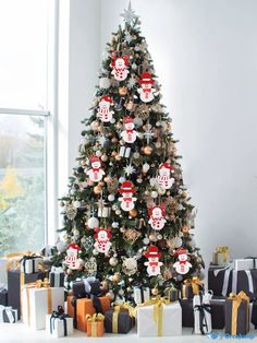 a decorated christmas tree with presents under it