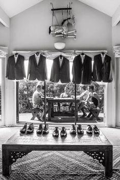 a man sitting in front of a table with shoes on it