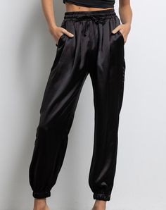 Color: Black Satin Jogger Elastic Waist With Drawstring Elastic Band At Ankle Pockets 100% Polyester Model is 5'8" 32-24-34 wearing a small Matching Satin Bomber- "Laverne" IJ2460 Black Silk Joggers Outfit, Black Satin Joggers Outfit, Satin Joggers Outfit Dressy, Silk Joggers Outfit, Satin Joggers Outfit, Black Satin Pants Outfit, Jogger Outfit Casual, Satin Pants Outfit, Nye 2024