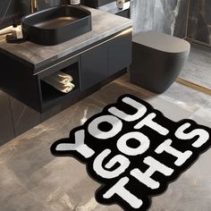 a black and white bathroom rug with the words yogurt on it