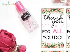 a pink rose next to two thank you cards and a bottle of perfume on a table