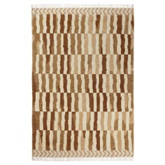 a brown and white rug with stripes on it