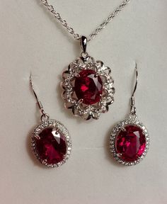 "Beautiful Deep Red Gem Necklace And Earring Set, 8x10mm Lab Grown Ruby Gems, 925 Sterling Silver Rhodium Plated Pendant With Cubic Zirconia Trim, 18\" Sterling Chain. 925 Sterling Rhodium Plated Earrings, Ear Wire Style. Gift Box Included." Ruby Wedding Jewelry, Ruby Jewelry Aesthetic, Ruby Necklace Set, Red Sterling Silver Fine Jewelry, Red Gemstone Accented Jewelry For Formal Occasions, Elegant Red Sterling Silver Jewelry, Ruby Pendant Necklace, Dazzling Lab-created Ruby Jewelry As Gift, Ruby Set