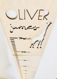 a wooden ruler with an image of a giraffe on it's side