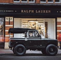 a black truck parked in front of a store