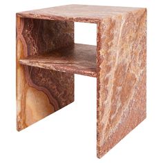 a marbled side table with shelves on each side