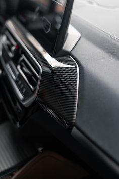 the interior of a modern car with carbon fiber and leather trim, including steering wheel controls