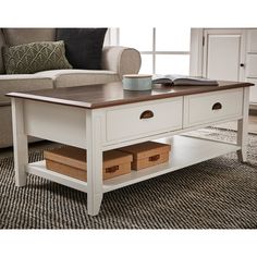 a white coffee table with two drawers on it