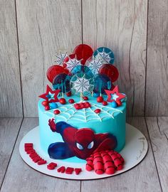 a spiderman cake with red, white and blue decorations