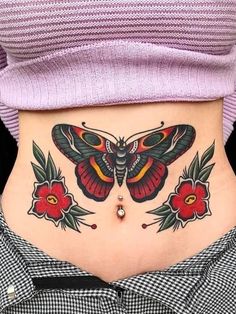 a woman's stomach with a butterfly tattoo on her belly and red flowers around it