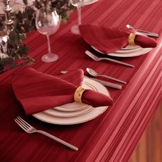 the table is set with red napkins and silverware